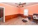 Bedroom with pink walls, ceiling fan, window, and debris at 355 Nassau St, Charleston, SC 29403