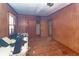 Dilapidated bedroom needing repair, with wood paneled walls and worn floors at 355 Nassau St, Charleston, SC 29403