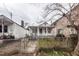 Exterior shot of home with covered porch, fenced front yard, and adjacent houses at 355 Nassau St, Charleston, SC 29403