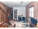 Hallway with stairs, wood paneling, window, and debris at 355 Nassau St, Charleston, SC 29403