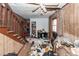 Living room reveals damage, including missing walls, a partially collapsed ceiling and debris at 355 Nassau St, Charleston, SC 29403