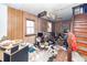 Living room with stairs, wood paneling, window, and debris at 355 Nassau St, Charleston, SC 29403