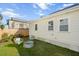Outdoor backyard featuring a grassy area and a cozy seating space with a unique fire pit at 42 Kennedy St, Charleston, SC 29403