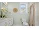 Bathroom with single sink, white vanity, gold hardware and fixtures, and combination shower and bathtub at 42 Kennedy St, Charleston, SC 29403