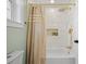 Bathroom with single sink, white vanity, gold hardware and fixtures, and combination shower and bathtub at 42 Kennedy St, Charleston, SC 29403