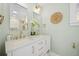 Bathroom featuring double sinks, white vanity, gold hardware and fixtures, and decorative mirror at 42 Kennedy St, Charleston, SC 29403