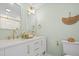 Bathroom featuring double sinks, white vanity, gold hardware and fixtures, and decorative mirror at 42 Kennedy St, Charleston, SC 29403