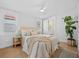 Bright bedroom with neutral color palette, large window, ceiling fan, and access to an ensuite bathroom at 42 Kennedy St, Charleston, SC 29403
