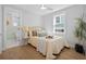 Bright bedroom with neutral color palette, large window, ceiling fan, and access to an ensuite bathroom at 42 Kennedy St, Charleston, SC 29403