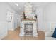 Cozy room featuring a unique brick fireplace with a wooden mantel, hardwood floors, and wainscoting details at 42 Kennedy St, Charleston, SC 29403