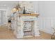 Charming white brick fireplace featuring a wood mantel, exposed brick, and stylish design at 42 Kennedy St, Charleston, SC 29403