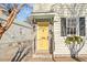 Charming home featuring a vibrant yellow front door, brick steps, and dark shutters adding character to its facade at 42 Kennedy St, Charleston, SC 29403