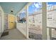 Cozy front porch featuring a yellow door, white columns, and a glimpse of the outdoors at 42 Kennedy St, Charleston, SC 29403