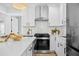 Bright kitchen features stainless steel appliances, marble countertops, and modern white cabinetry at 42 Kennedy St, Charleston, SC 29403