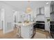 Modern white kitchen featuring a center island with seating and stainless steel appliances at 42 Kennedy St, Charleston, SC 29403