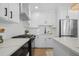 Modern kitchen with white cabinets, stainless steel appliances, kitchen island, and stylish backsplash at 42 Kennedy St, Charleston, SC 29403