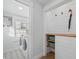 Bright laundry room with modern appliances, shiplap accent wall, and practical storage solutions at 42 Kennedy St, Charleston, SC 29403