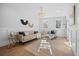 Bright living room featuring hardwood floors, modern furniture, and a stylish chandelier creating an inviting ambiance at 42 Kennedy St, Charleston, SC 29403