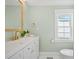 Charming powder room with a decorative mirror, gold fixtures, and a modern toilet at 42 Kennedy St, Charleston, SC 29403