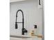 Close-up of a modern kitchen sink with a black faucet and stylish backsplash at 42 Kennedy St, Charleston, SC 29403