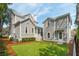 Backyard with a well-manicured artificial lawn and gray two-story house at 425 Mccants Dr, Mount Pleasant, SC 29464