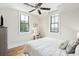 Bright bedroom with hardwood floors, two windows, and a comfortable bed with patterned pillows at 425 Mccants Dr, Mount Pleasant, SC 29464