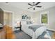 Bright bedroom with a ceiling fan, two bedside lamps and decorative prints adorning the walls at 425 Mccants Dr, Mount Pleasant, SC 29464