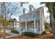 Beautiful two-story home with a charming front porch, dormer windows, and a professionally landscaped yard at 425 Mccants Dr, Mount Pleasant, SC 29464