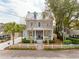 Charming two-story home with a metal roof, front porch, and manicured landscaping on a sunny day at 425 Mccants Dr, Mount Pleasant, SC 29464