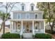 Charming two-story home with a welcoming front porch, dormer windows, and landscaped yard at 425 Mccants Dr, Mount Pleasant, SC 29464
