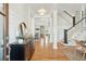 Bright foyer with hardwood floors, a wooden door, white wainscoting, and an open staircase at 425 Mccants Dr, Mount Pleasant, SC 29464