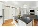Open kitchen and living area featuring an island with bar seating, storage, and stainless steel microwave at 425 Mccants Dr, Mount Pleasant, SC 29464