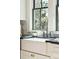 Farmhouse sink with chrome faucet, set in front of two windows in a bright kitchen at 425 Mccants Dr, Mount Pleasant, SC 29464