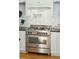 Well-appointed kitchen featuring a Bertazzoni range and pot filler faucet against a marble tile backsplash at 425 Mccants Dr, Mount Pleasant, SC 29464