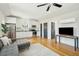 Open-concept kitchen and living area with stainless steel appliances, white cabinets, and a comfortable sofa at 425 Mccants Dr, Mount Pleasant, SC 29464