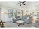 Cozy living area flows into kitchen with gray sofa and ample natural light at 425 Mccants Dr, Mount Pleasant, SC 29464