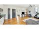 Bright living room featuring hardwood floors, modern exercise equipment, and a view to a connected bedroom at 425 Mccants Dr, Mount Pleasant, SC 29464