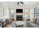 Bright living room featuring fireplace, TV, neutral walls, and large windows at 425 Mccants Dr, Mount Pleasant, SC 29464