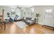 Inviting living room featuring hardwood floors, bright windows, and modern exercise equipment in a well-lit space at 425 Mccants Dr, Mount Pleasant, SC 29464