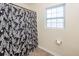 Bathroom features a bathtub, shower with decorative curtain and window for natural light at 426 Mountain Laurel Cir, Goose Creek, SC 29445