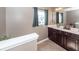 Neutral bathroom with double sinks, a mirror, and a green plant at 426 Mountain Laurel Cir, Goose Creek, SC 29445