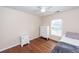 Cozy bedroom with a ceiling fan, two dressers, wood floors, and natural light from the window at 426 Mountain Laurel Cir, Goose Creek, SC 29445