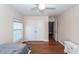 Bedroom featuring wood floors, ceiling fan, closet, window, and a white dresser in a neutral color scheme at 426 Mountain Laurel Cir, Goose Creek, SC 29445