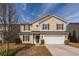 Charming two-story home featuring a manicured lawn, attached two-car garage and classic curb appeal at 426 Mountain Laurel Cir, Goose Creek, SC 29445