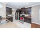 A modern kitchen features stainless steel appliances, dark cabinets, granite countertops and tile floors at 426 Mountain Laurel Cir, Goose Creek, SC 29445