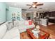 Open-concept living space with hardwood floors, a ceiling fan, and a view into the modern kitchen at 426 Mountain Laurel Cir, Goose Creek, SC 29445