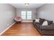 Spacious living room with two bright windows, hardwood floors, and a comfortable couch at 426 Mountain Laurel Cir, Goose Creek, SC 29445