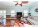 Inviting living room boasts hardwood floors, with large windows and a ceiling fan, offering a relaxed atmosphere at 426 Mountain Laurel Cir, Goose Creek, SC 29445