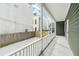 Inviting covered back porch with white railing overlooking a well maintained backyard and fence at 5 Maranda Holmes St, Charleston, SC 29403