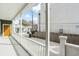 Inviting covered back porch with white railing overlooking a well maintained backyard and fence at 5 Maranda Holmes St, Charleston, SC 29403
